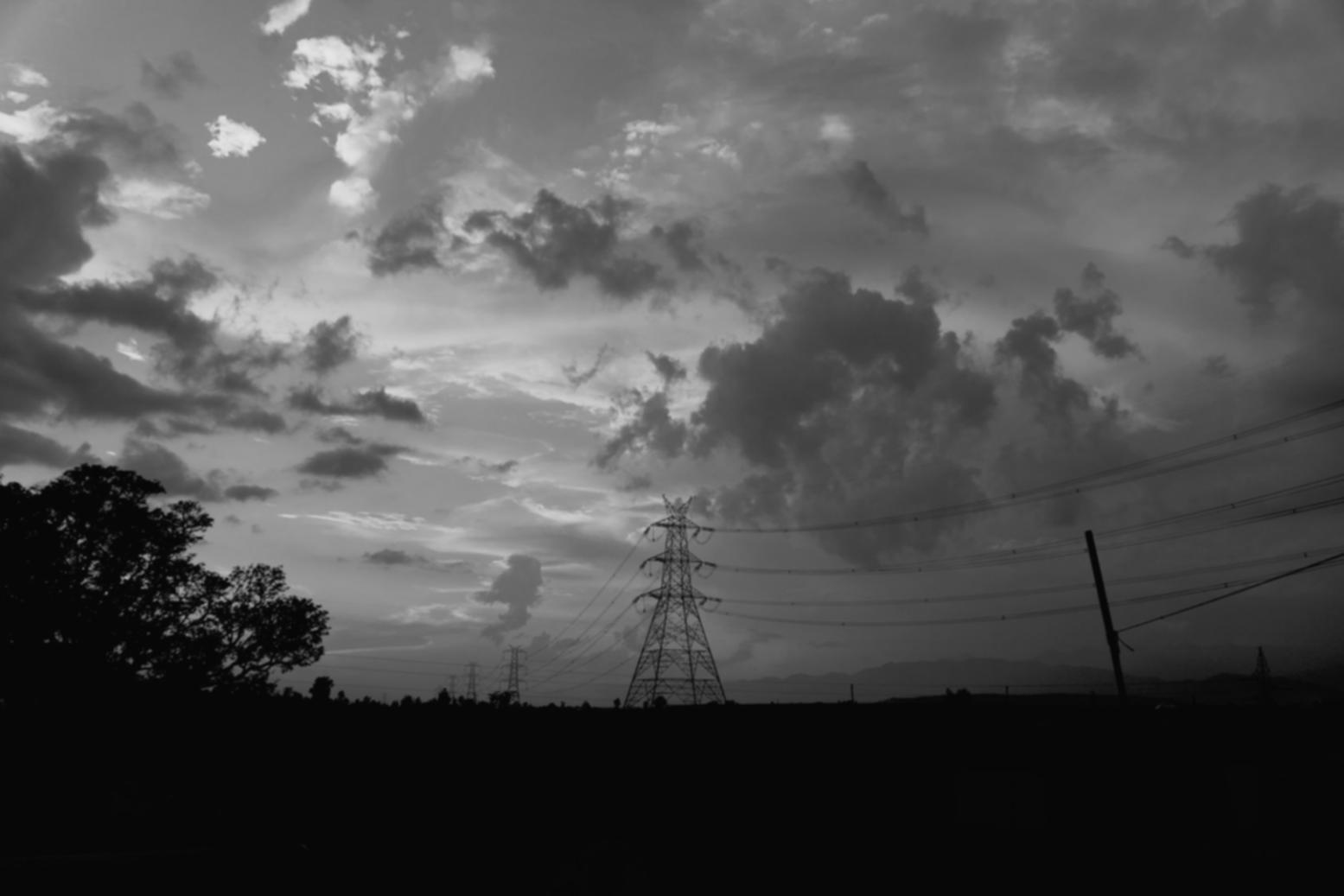 Technician inspecting solar panel installation on commercial building rooftop with safety equipment